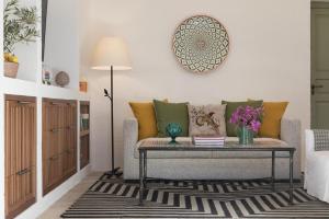 a living room with a couch and a table at Rocco Forte Masseria Torre Maizza in Savelletri di Fasano