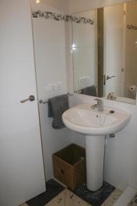 a white bathroom with a sink and a mirror at Fantastic, 100 meters from the beach in Can Picafort +29 photos