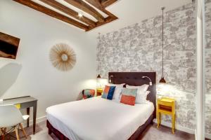 a bedroom with a bed and a desk at Hôtel Sèvres Saint Germain in Paris +20 photos