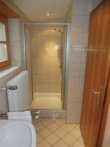 a bathroom with a shower and a toilet and a sink at Haus Eicher in Schneizlreuth