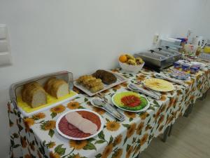 a table with a table cloth with food on it at Acopark Vendégház in Debrecen