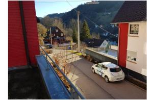 a white car parked on the side of a street at Talstadtblick in Schramberg