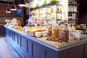 a bar with a counter with jars of food at Frederick Street Townhouse in Birmingham
