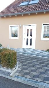 a house with a white door and a driveway at Evi's Apartment in Regensburg