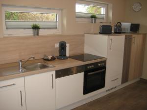a kitchen with a sink and a counter top at City-Apartment Rietberg in Rietberg