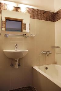 a bathroom with a sink and a bath tub at Pella in Thessaloniki