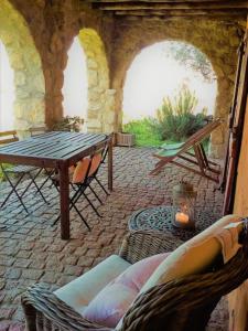 a patio with a table and chairs in a stone building at Quinta Do Marvao in Marvão