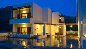 a house in the rain at night at Syia Hotel in Sougia