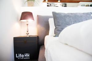 a lamp on a night stand next to a bed at Apartment Maria Detmold in Detmold