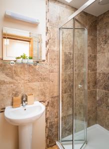 a bathroom with a shower and a sink at St Sidwells Townhouses' in Exeter