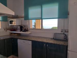 a kitchen with blue cabinets and a counter top at Apartament Casa Bonfill in L'Ampolla