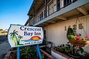 a sign outside of a bay inn with a sign for a resort at Crescent Bay Inn in Laguna Beach