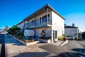 a white building with a sign in front of it at Crescent Bay Inn in Laguna Beach