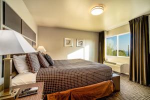 a hotel room with a bed and a window at Crescent Bay Inn in Laguna Beach