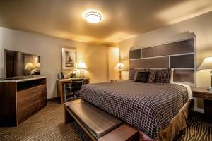 a hotel room with a bed and a desk at Crescent Bay Inn in Laguna Beach
