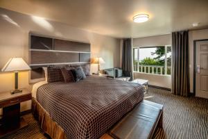 a hotel room with a bed and a window at Crescent Bay Inn in Laguna Beach