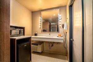 a bathroom with a sink and a mirror at Crescent Bay Inn in Laguna Beach