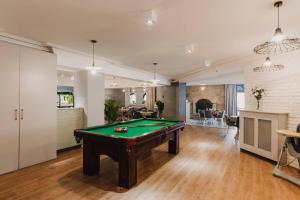 a living room with a pool table in it at Hotel Rozdroże Nieborów in Nieborów