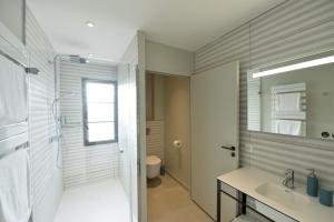 a bathroom with a shower and a sink and a mirror at Demeure Larmandier in Les Mesneux