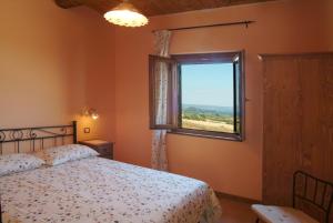 Postel nebo postele na pokoji v ubytování Agriturismo Le Ginestre