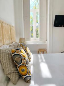 a living room with a couch and a window at WW Hostel & Suites in Coimbra