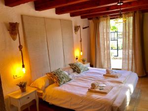 a bedroom with a large bed with towels on it at Agroturismo Can Guillo in Pollença +116 photos