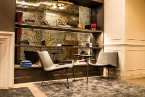 a room with two chairs and a desk and shelves at Hotel 32 32 in New York