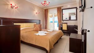 een hotelkamer met een bed met handdoeken erop bij Ilia Mare in Ilia