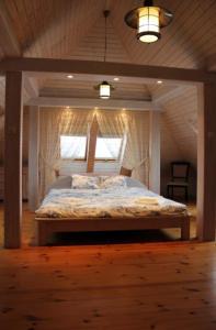 a bedroom with a bed in a wooden room at DWÓR POD RÓŻAMI in Smolec