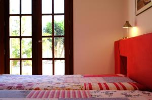 a bedroom with a bed and a window at La Posidonia in Rodalquilar