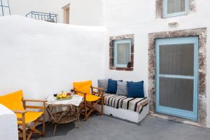 a patio with a couch and chairs and a table at Black Rock Traditional Rooms in Emporio