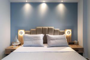 a bedroom with a large bed with two white pillows at Oasis in Sarti