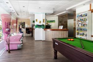 a billiard room with a pool table and a bar at Bayside Salgados in Albufeira