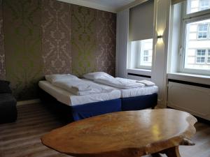 Llit o llits en una habitació de AVI City Burgplatz Apartments