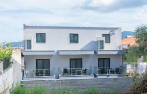 a white house with a balcony at Oasis in Sarti