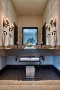 a bathroom with two sinks and a large mirror at Hotel Domestique in Riverview