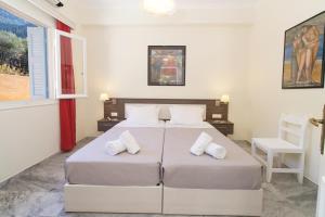 two beds in a bedroom with two pillows at Prince Studios in Sami