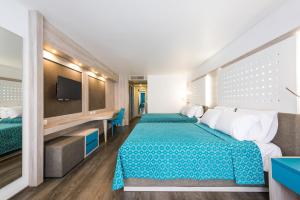 Una cama o camas en una habitación de Hotel Casa Blanca