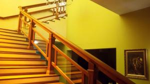 a staircase in a house with yellow walls at Canoas Parque Hotel in Canoas
