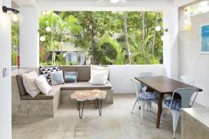 a living room with a couch and a table at Villa Dorado - Duplex in Sayulita