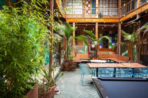 an outdoor patio with tables and chairs and plants at Socialtel Candelaria Bogotá in Bogotá