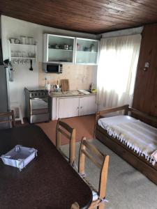 a kitchen and dining room with a table in a room at Conaguademar in La Paloma