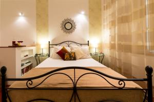 a bedroom with a bed with white sheets and pillows at Studio Sonnet in Dubrovnik