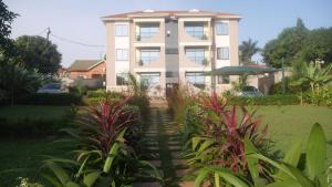 a house with a garden in front of it at Ntinda View Apartments in Kampala