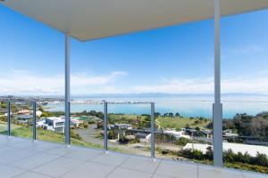 a view of the ocean from the balcony of a building at Aqua-Heights Apartment in Nelson