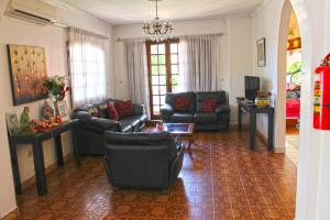 a living room with couches and a chandelier at Ross Char Hotel in Asuncion