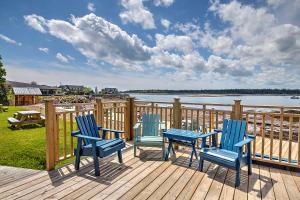 three blue chairs sitting on a deck overlooking a body of water at Seaside Beach Resort in Saint Andrews