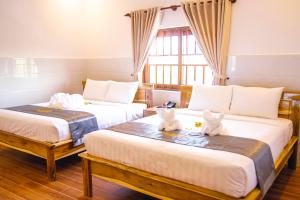 Postel nebo postele na pokoji v ubytování Mui Ne Beach Hotel