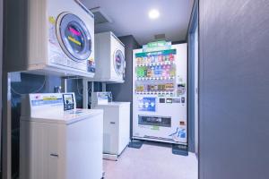a large white refrigerator in a store with a drink at E Hotel Higashi Shinjuku in Tokyo
