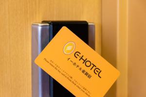 a yellow sign on top of a bottle of alcohol at E Hotel Higashi Shinjuku in Tokyo +92 photos